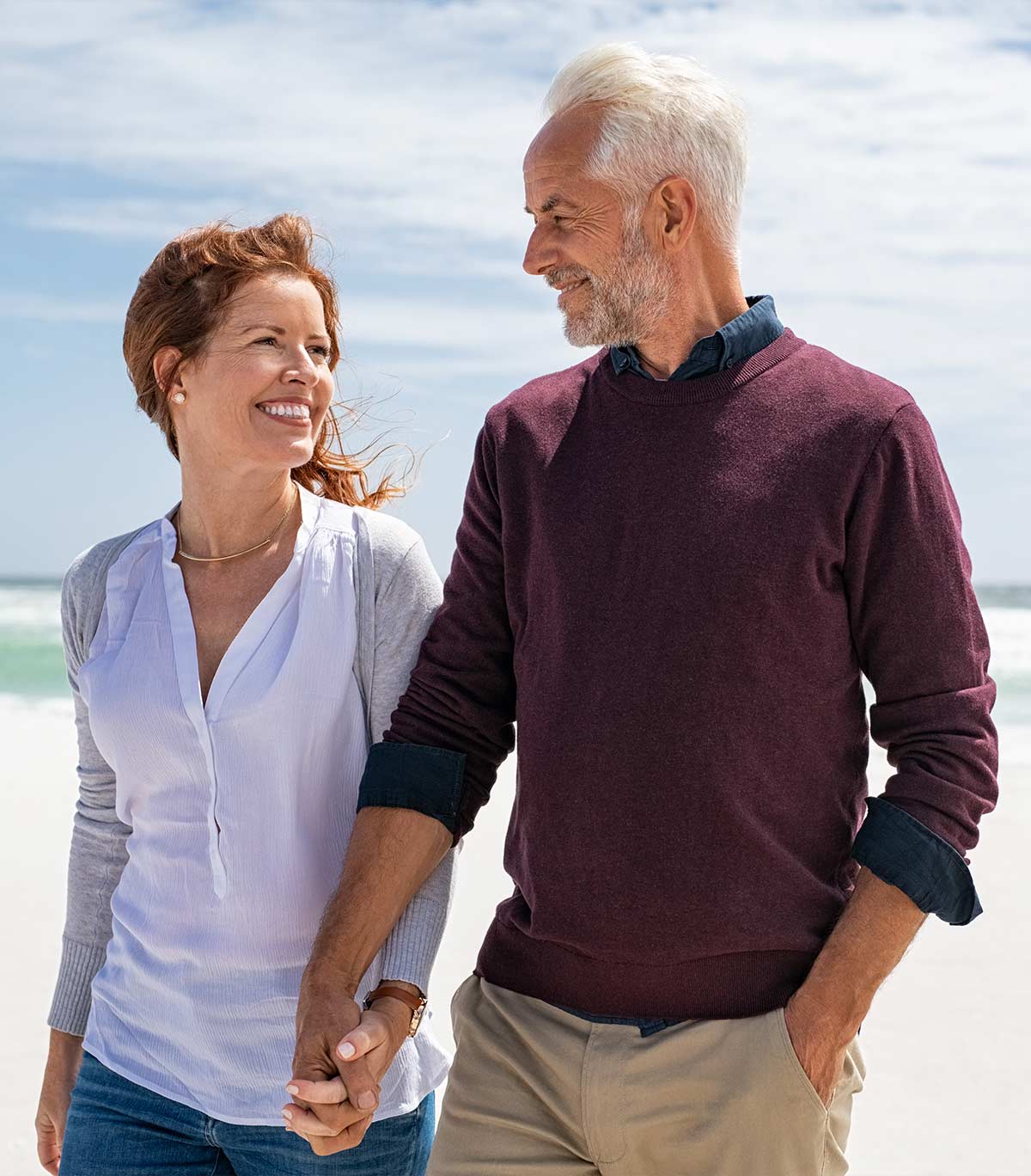 couple holding hands at the beach wealth management strategies tallahasee fl