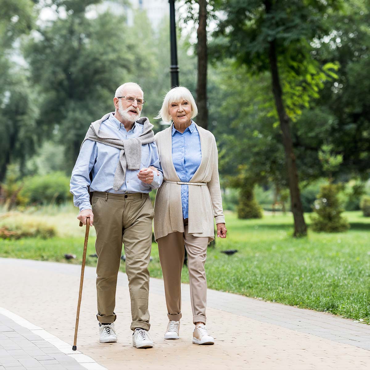 couple walking in park with arms locked guaranteed retirement income tallahassee fl